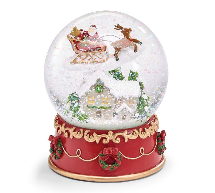 Burton+Burton Christmas decor snow globe featuring festive holiday scene with snow-covered house and Christmas trees inside.