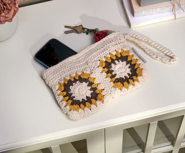 Crochet sunflower wristlet clutch purse with zipper, cotton material, women's accessory by Primitives by Kathy, featuring floral design.