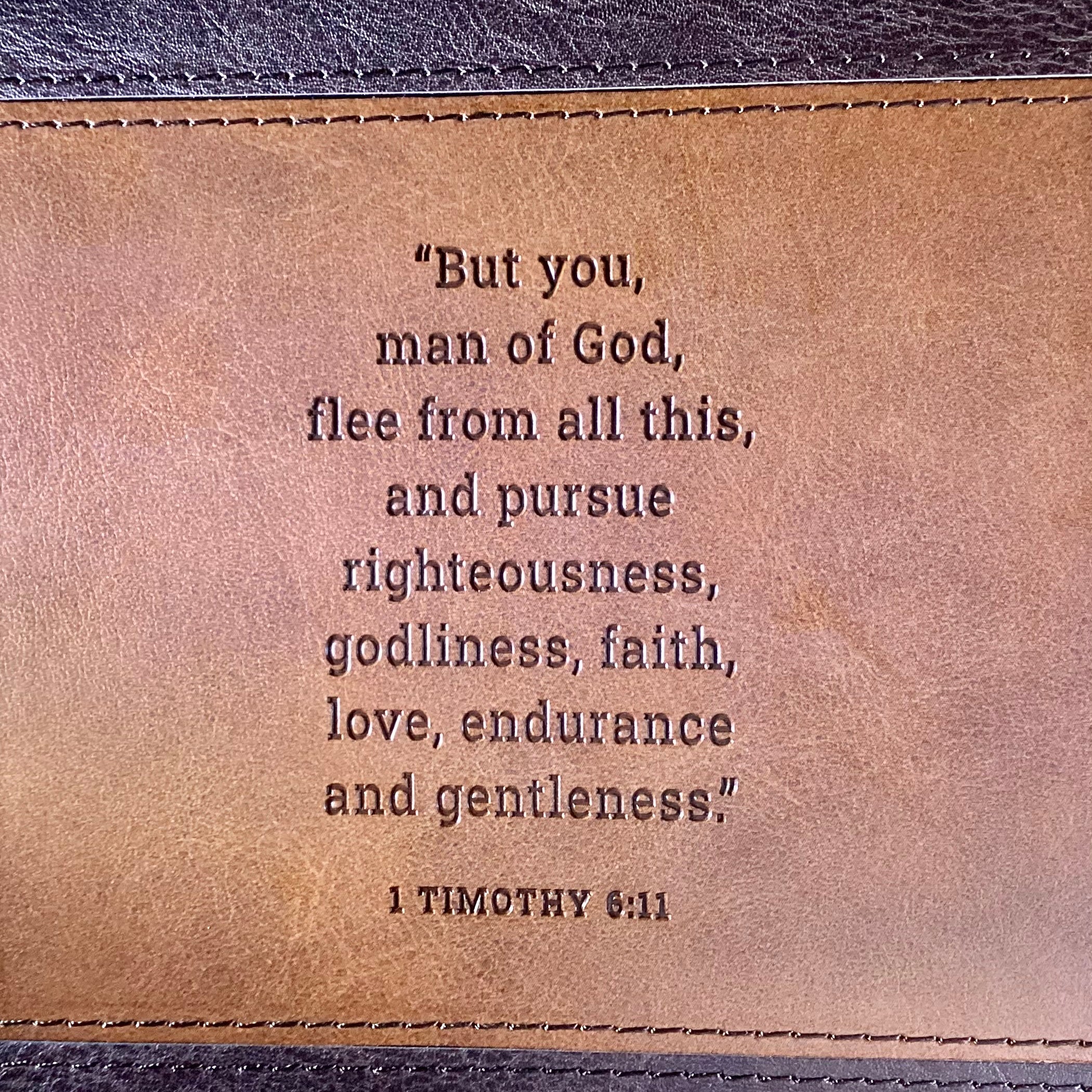 Man of God faux leather journal by Christian Art Gifts with gold accents and scripture pages, featuring a sleek, durable cover.