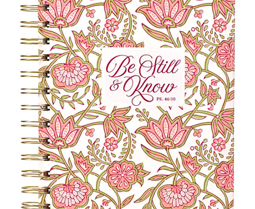 Pink floral spiral journal with gold binding, titled "Be Still and Know," designed by Christian Art Gifts for reflection and note-taking.