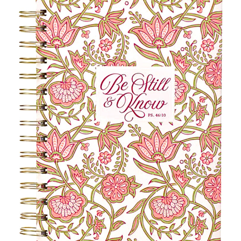 Pink floral spiral journal with gold binding, titled "Be Still and Know," designed by Christian Art Gifts for reflection and note-taking.