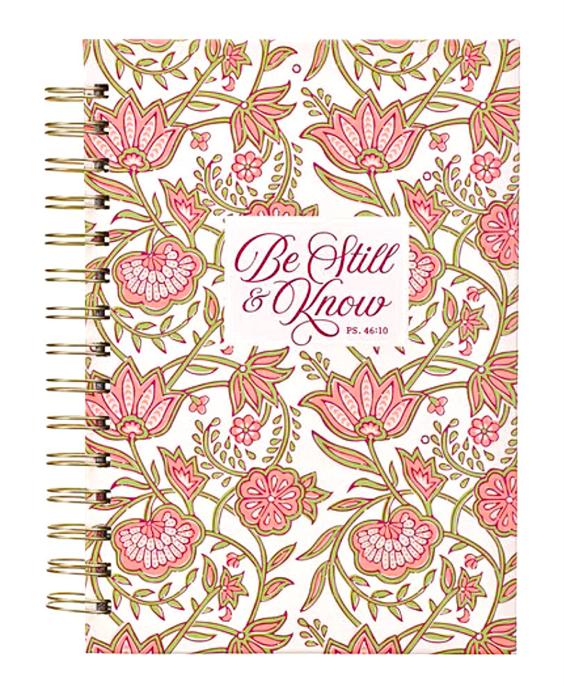 Pink floral spiral journal with gold binding, titled "Be Still and Know," designed by Christian Art Gifts for reflection and note-taking.