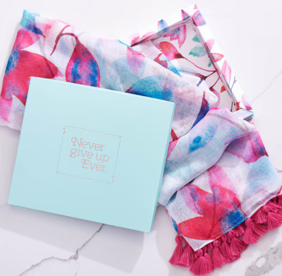 Pink floral Christian Art Gifts women's scarf displayed in a gift box, showcasing vibrant flower patterns and soft fabric.
